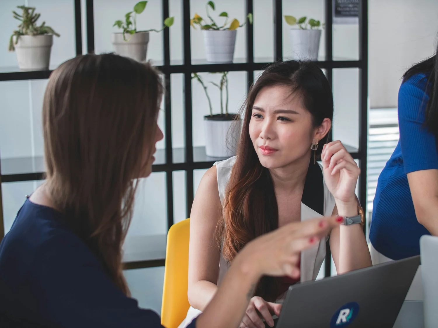 Two people talking together during a meeting